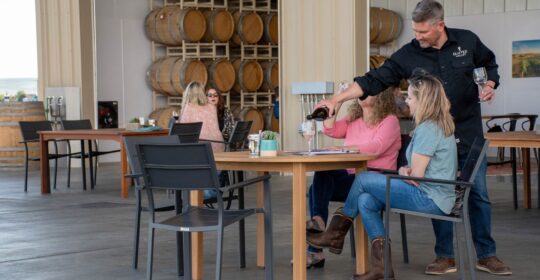 Winemaker Chad pouring wine.