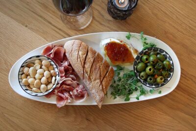 Assorted meats, bread, and olives.