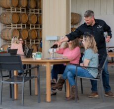 Winemaker, Chad, pouring wine for guests.